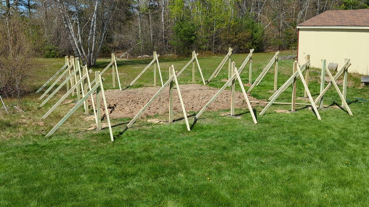 Fence posts set in concrete and braced with other lumber