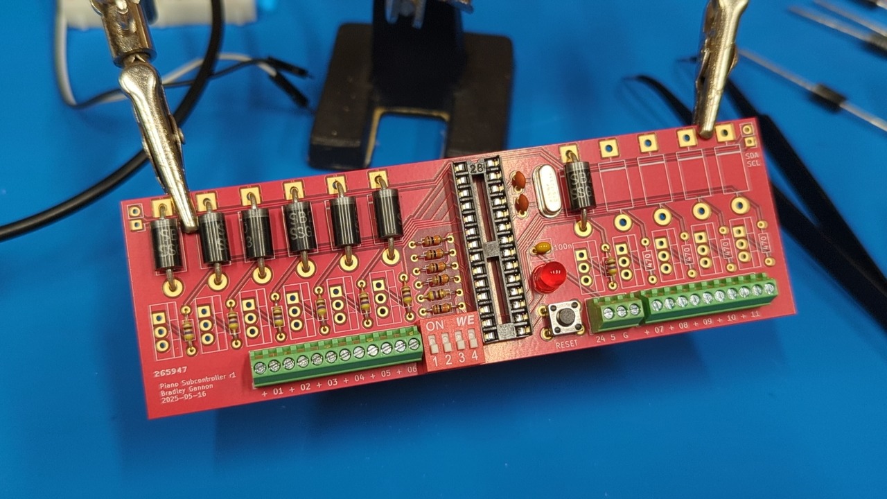 A third hand holds a red circuit board with several repeating columns of diodes, resistors, and screw terminals, along with some other unpopulated footprints and components