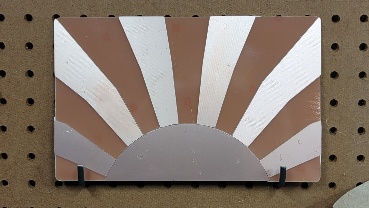 The sunrise design from part one, but assembled out of actual materials and resting on hooks hanging from my pegboard