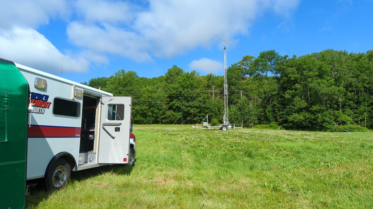 Waldo EMA’s communications truck sits parked near a portable aluminum tower in a field