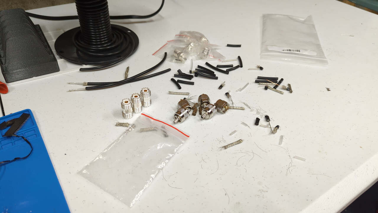 Various coax cable detritus (jackets, shields, and mangled dielectrics) in a loose pile on my workbench