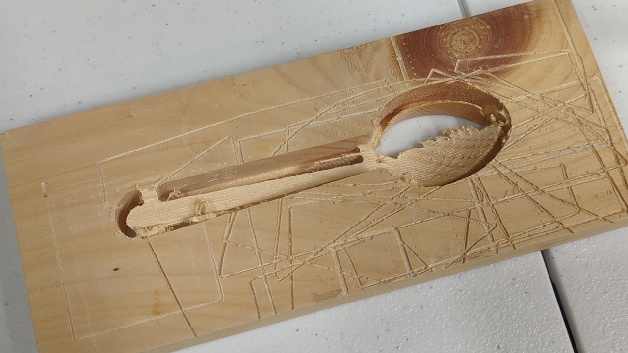 Spoon-shaped cutout with a big chunk of the head part missing, viewed from above