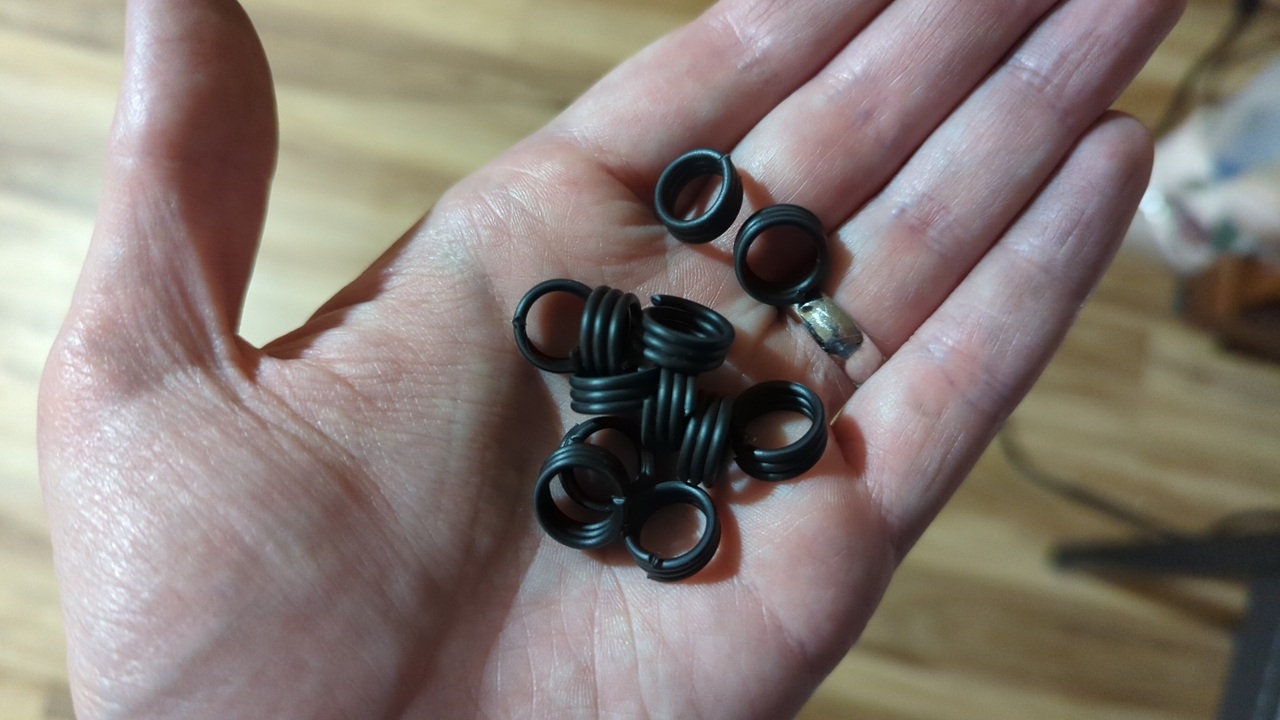A small pile of three-turn springs in my hand which I cut from the windings in the previous photo.