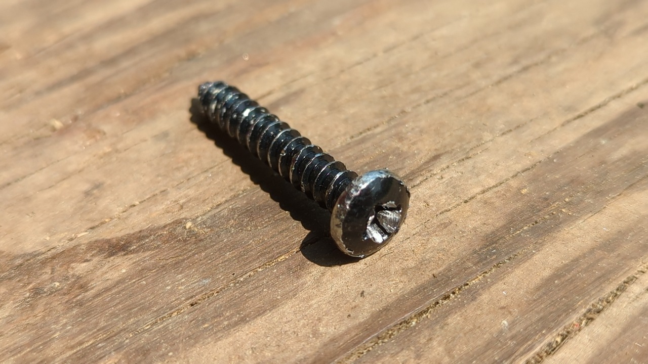 A screw from the fence gate kit that I stripped during installation